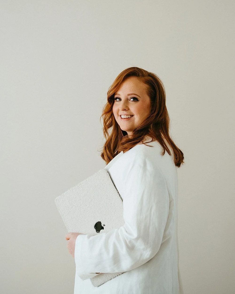 Manon Atlass staat met haar laptop onder haar arm